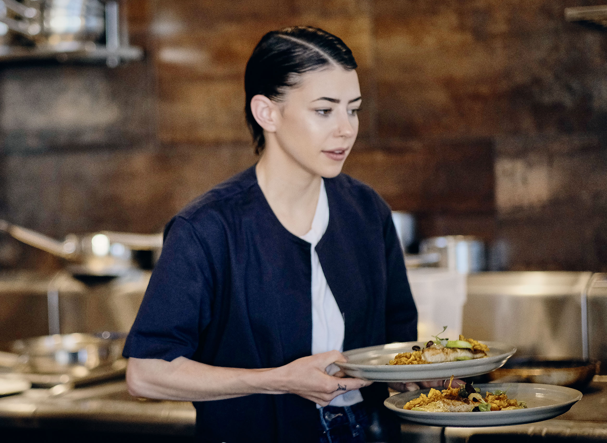 Ahi Waitress Carrying Plates in Dining Room • Hospitality & Culinary Food Photography