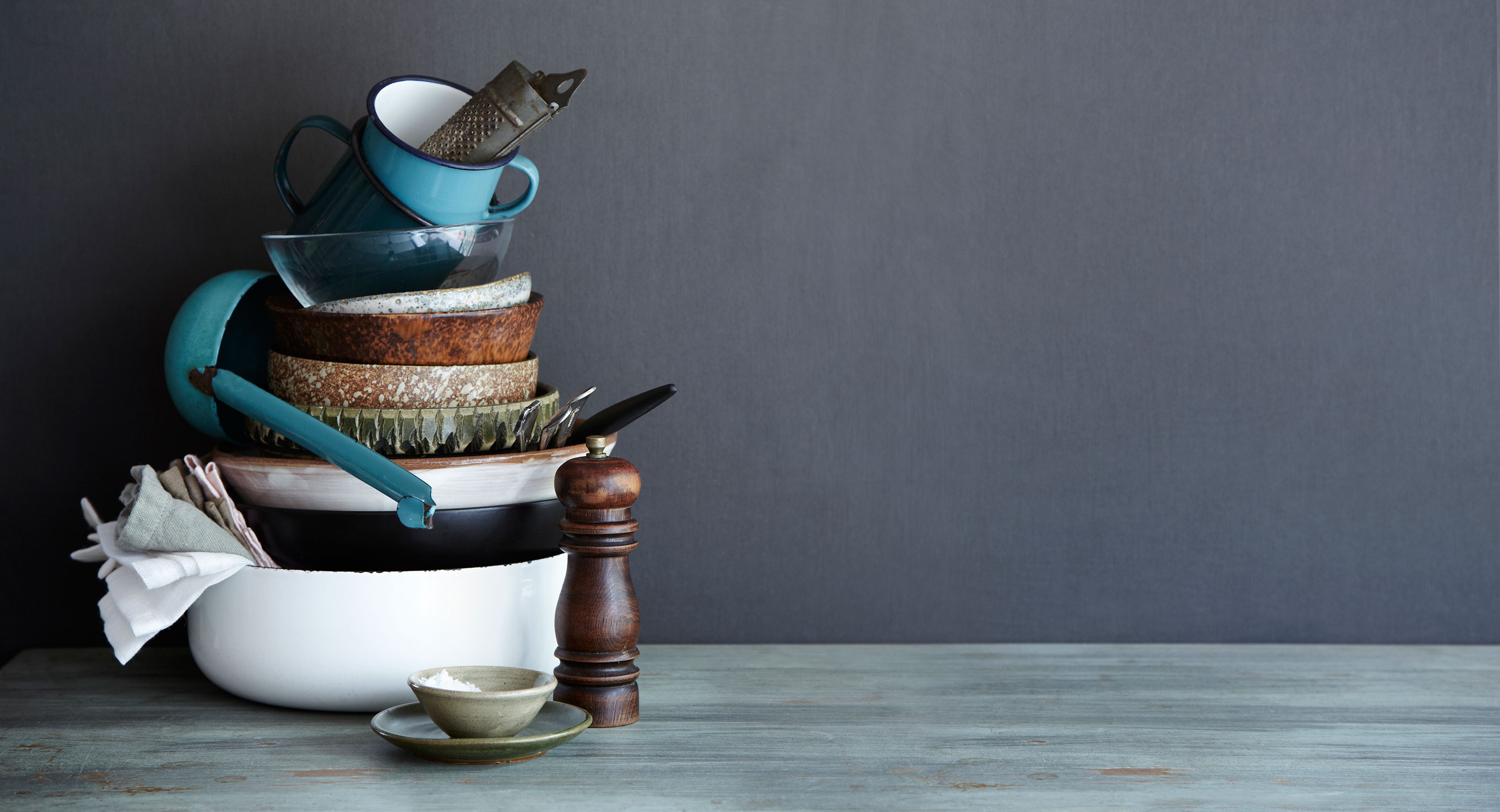 Everyday • Rustic Ceramic & Enamel Stacked Soup Bowls on Dark Wooden Bench • Hospitality & Editorial Food Photography