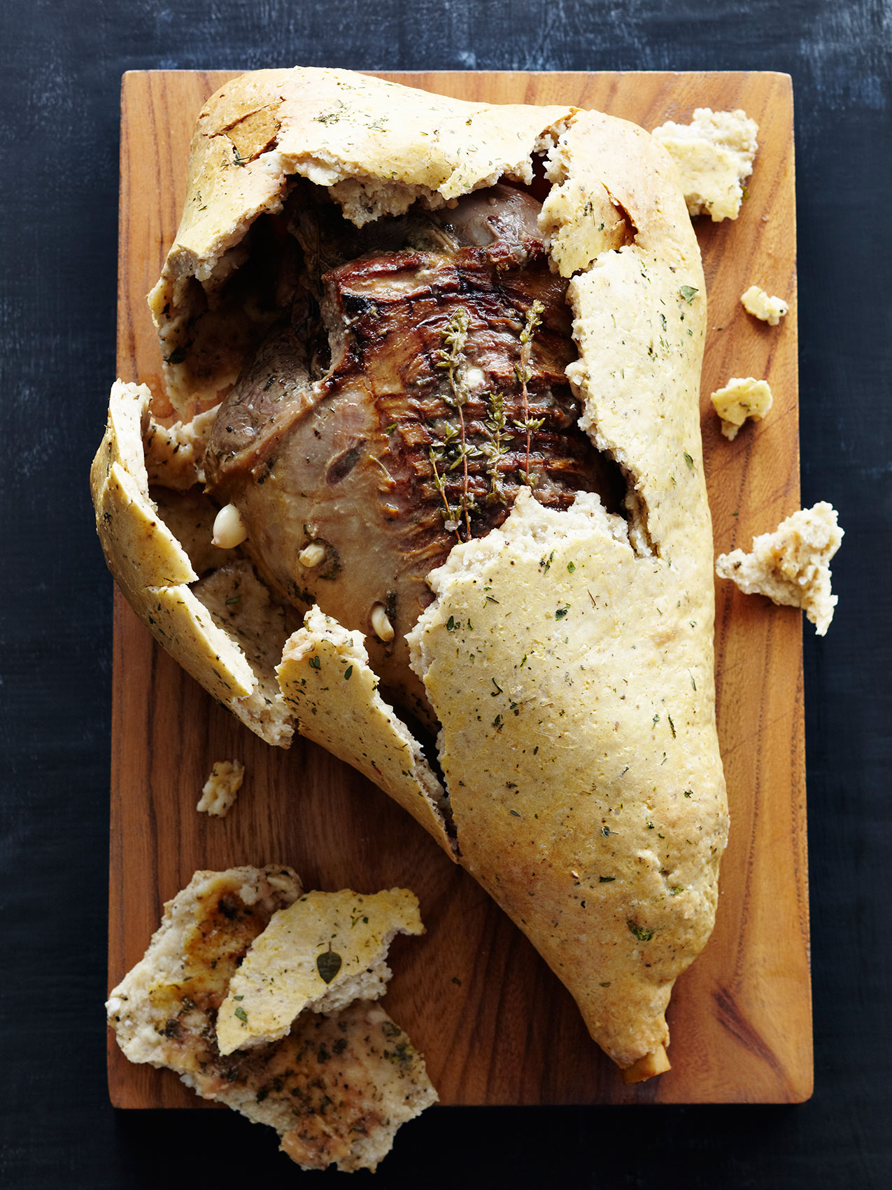 Laesoe Salt • Salt Crust Lamb Leg with Fresh Herbs on Wooden Board • Advertising & Lifestyle Food Photography