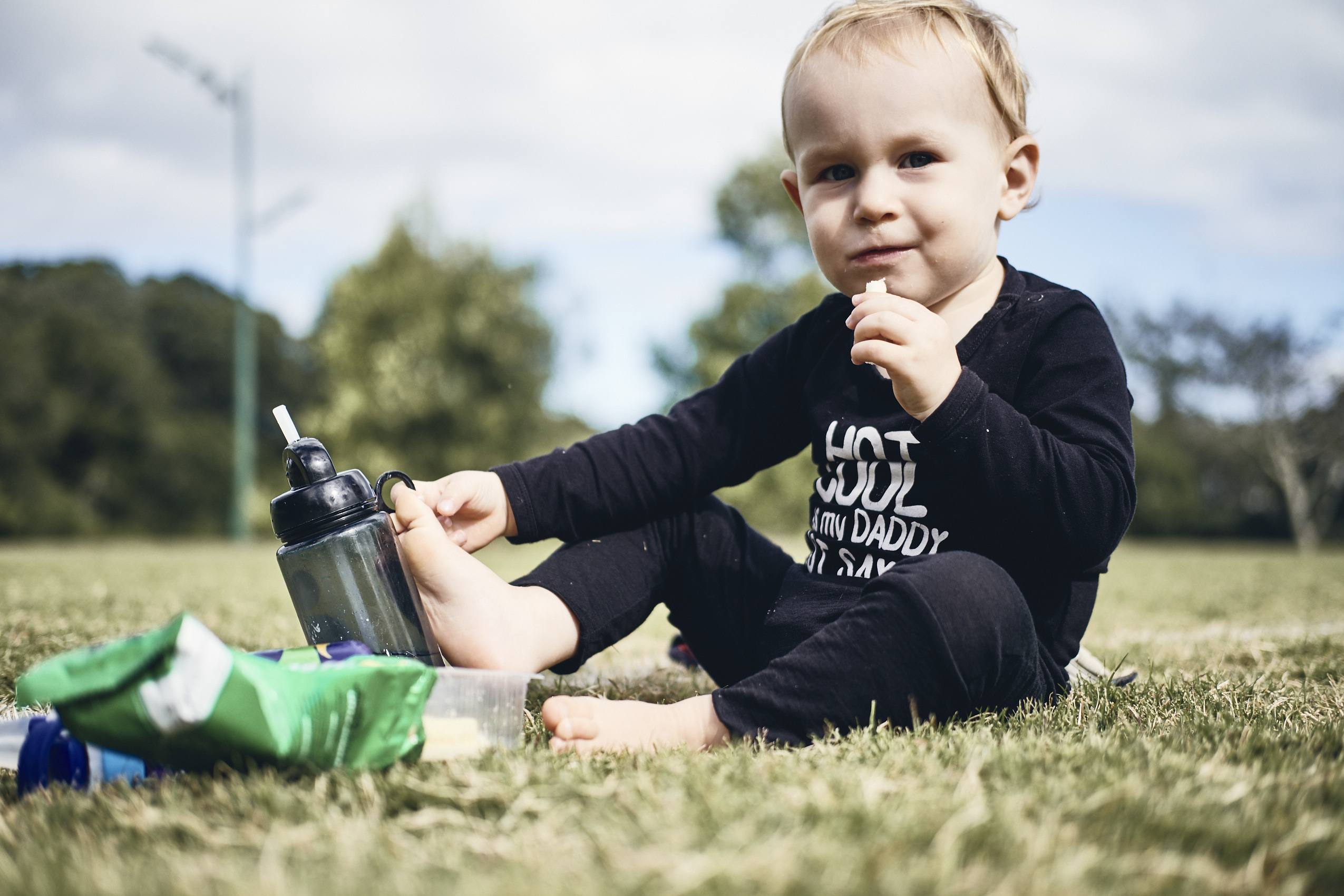 Lockdown • Toddler Sitting Down Snacking in Park  • Lifestyle & Portrait Photography