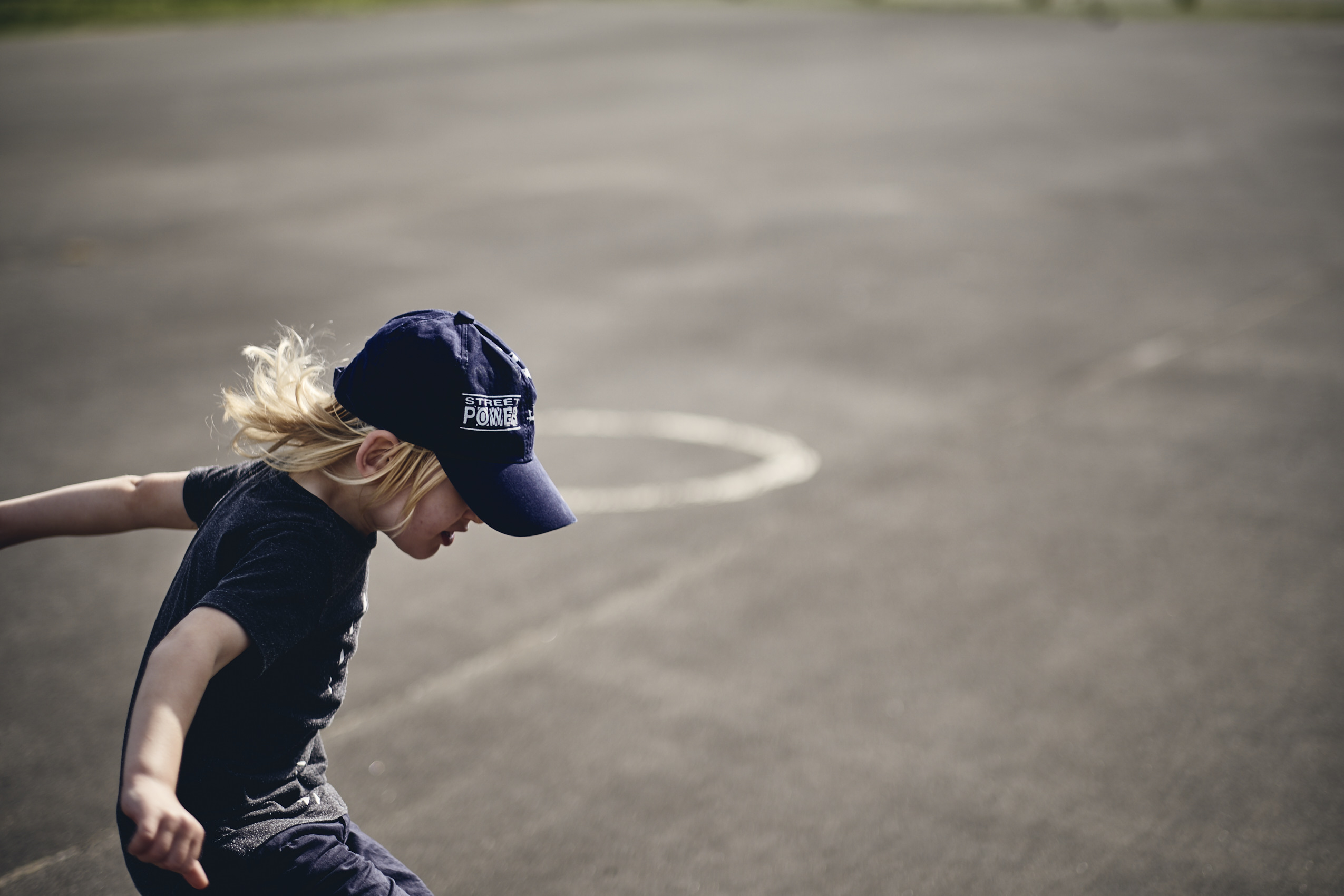 Lockdown • Young Boy in Cap Jumping on Asphalt • Lifestyle & Portrait Photography