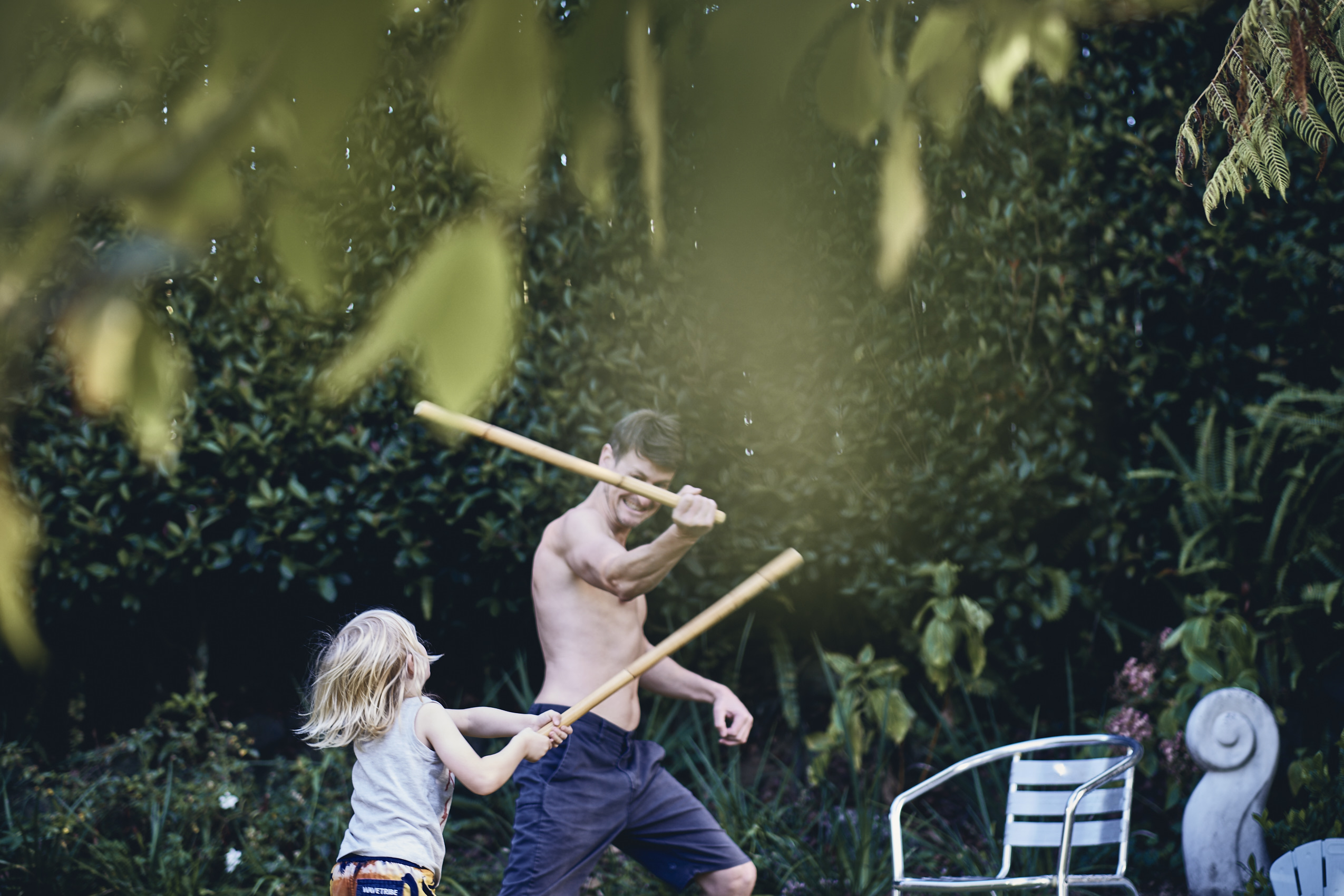 Lockdown • Father & Son Sword fighting with Sticks in Garden • Lifestyle & Portrait Photography