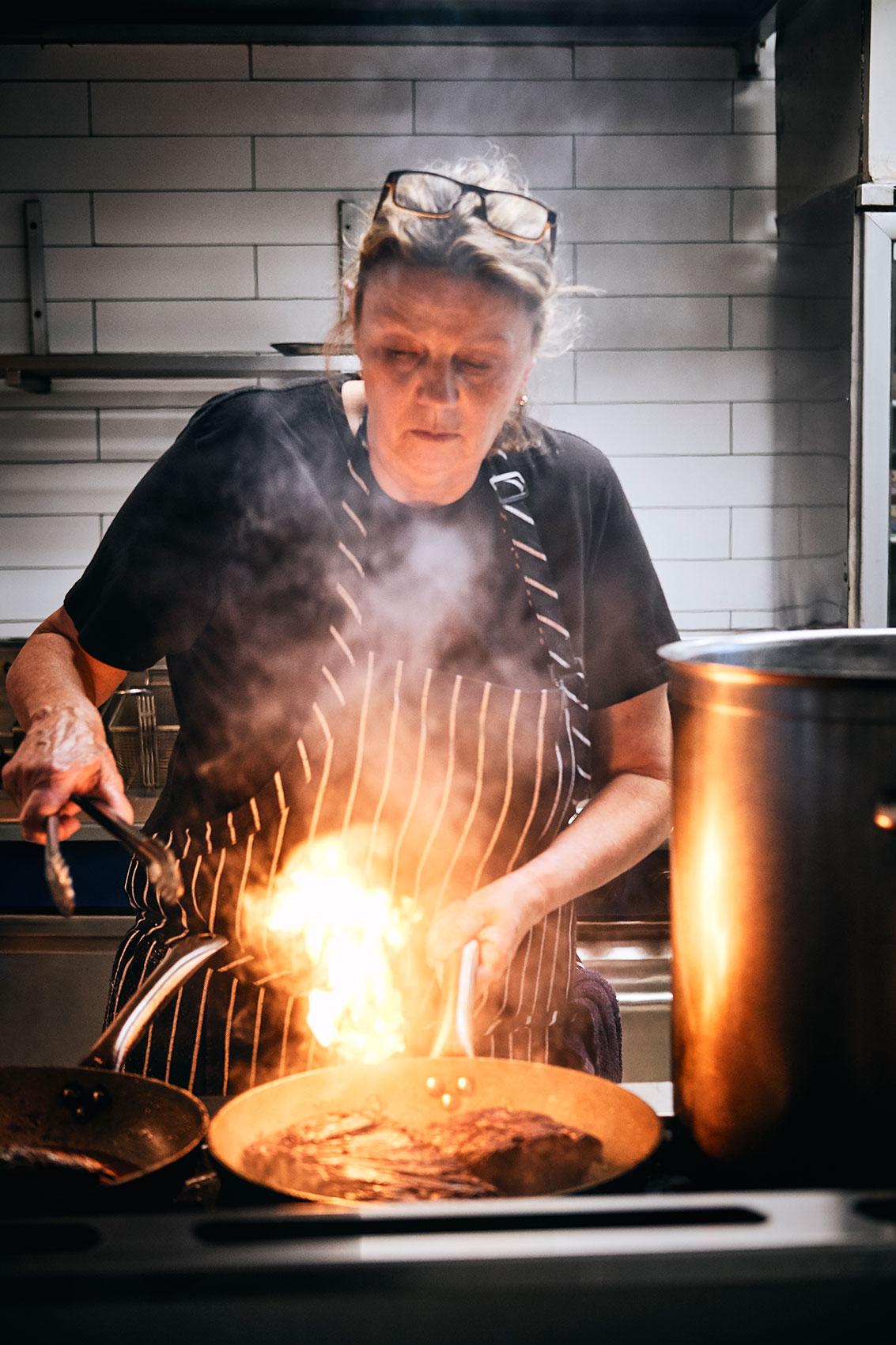 Mother Chef • Female  Chef Kate Fay of Cibo Parnell Frying Steak over Flame • Editorial & Lifestyle Photography