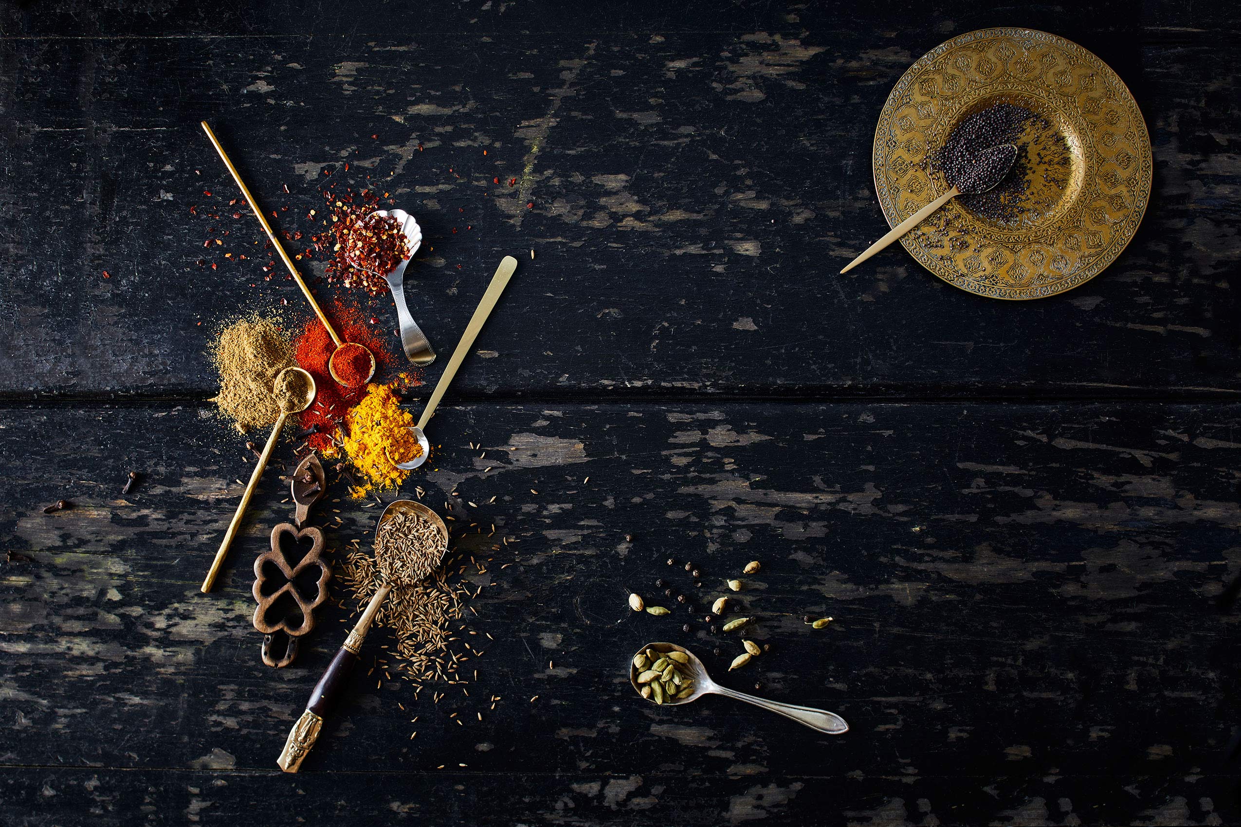 My Indian Kitchen • Colourful Powdered Spices on Distressed Table • Cookbook & Editorial Food Photography