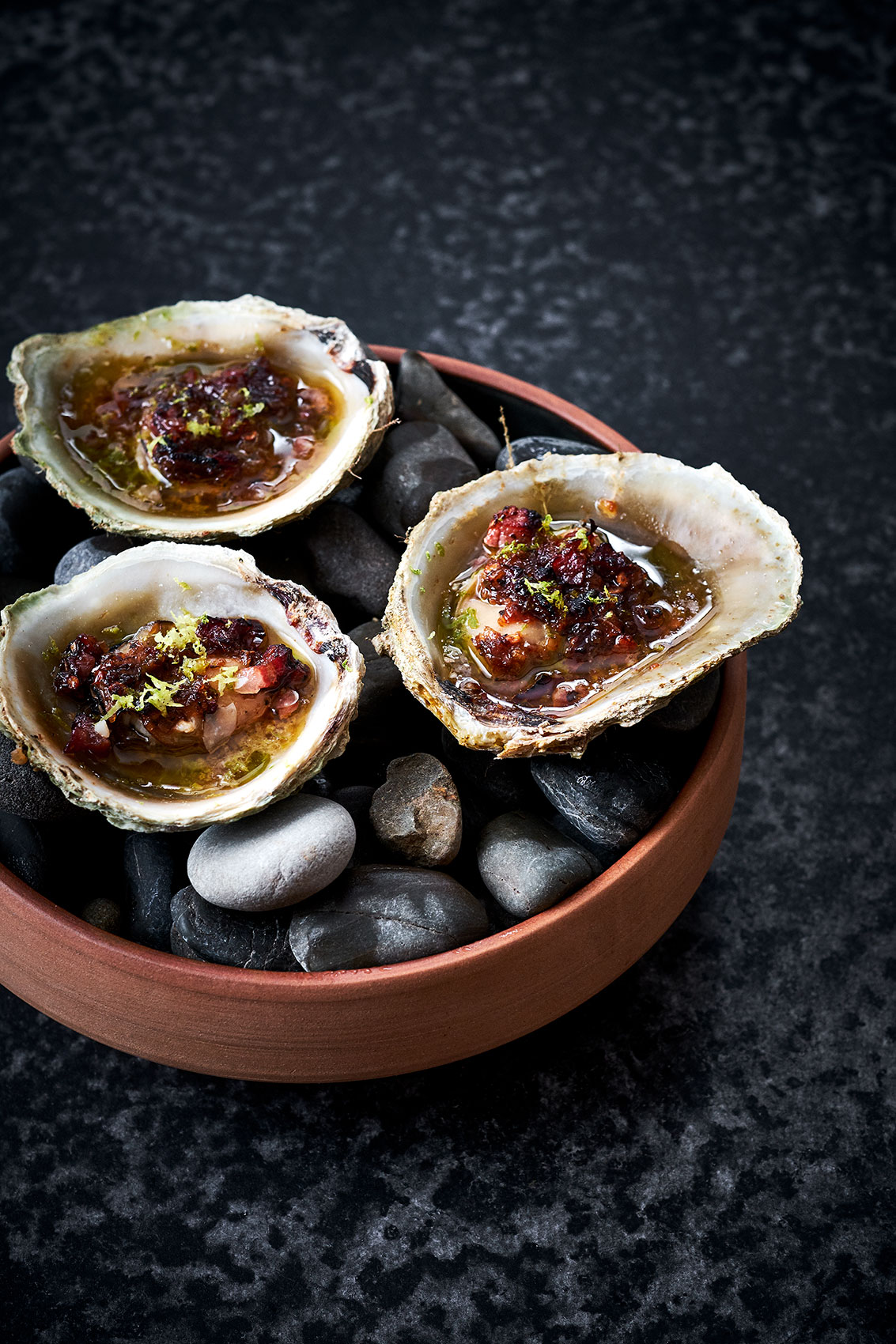 Hiakai • Savoury New Zealand Bluff Oyster Lardon on River Rocks • Lifestyle & Hospitality Food Photography