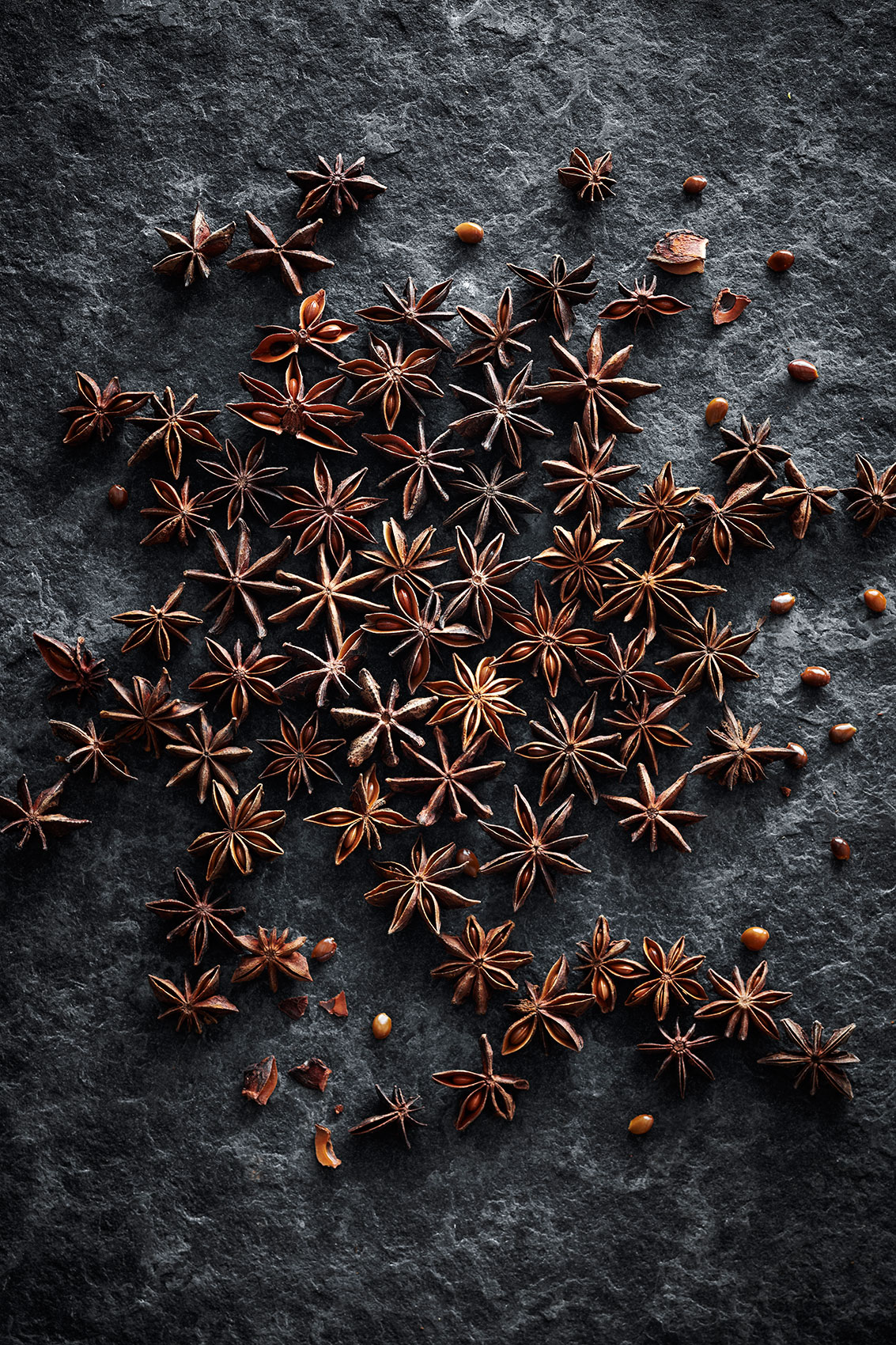 Spice Health Heroes • Whole Dried Star Anise Pods on Dark Textured Counter • Cookbook & Editorial Food Photography