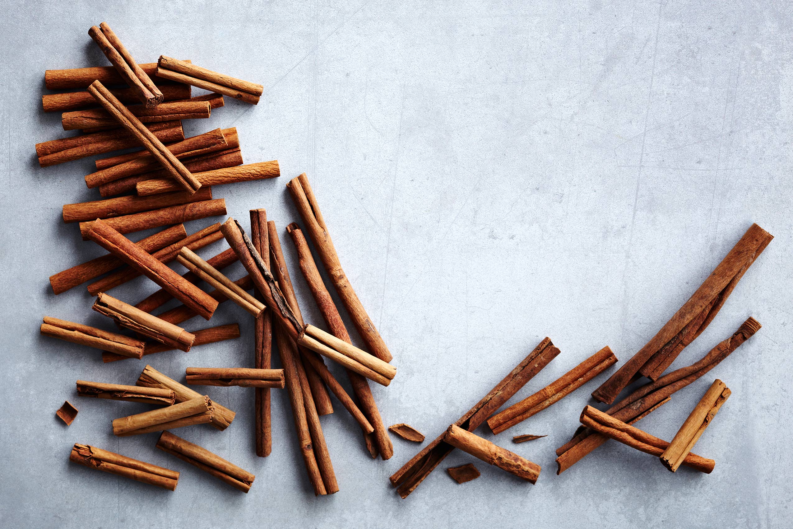 Spice Health Heroes • Whole Dried Cinnamon Sticks on Light Stone Counter • Cookbook & Editorial Food Photography