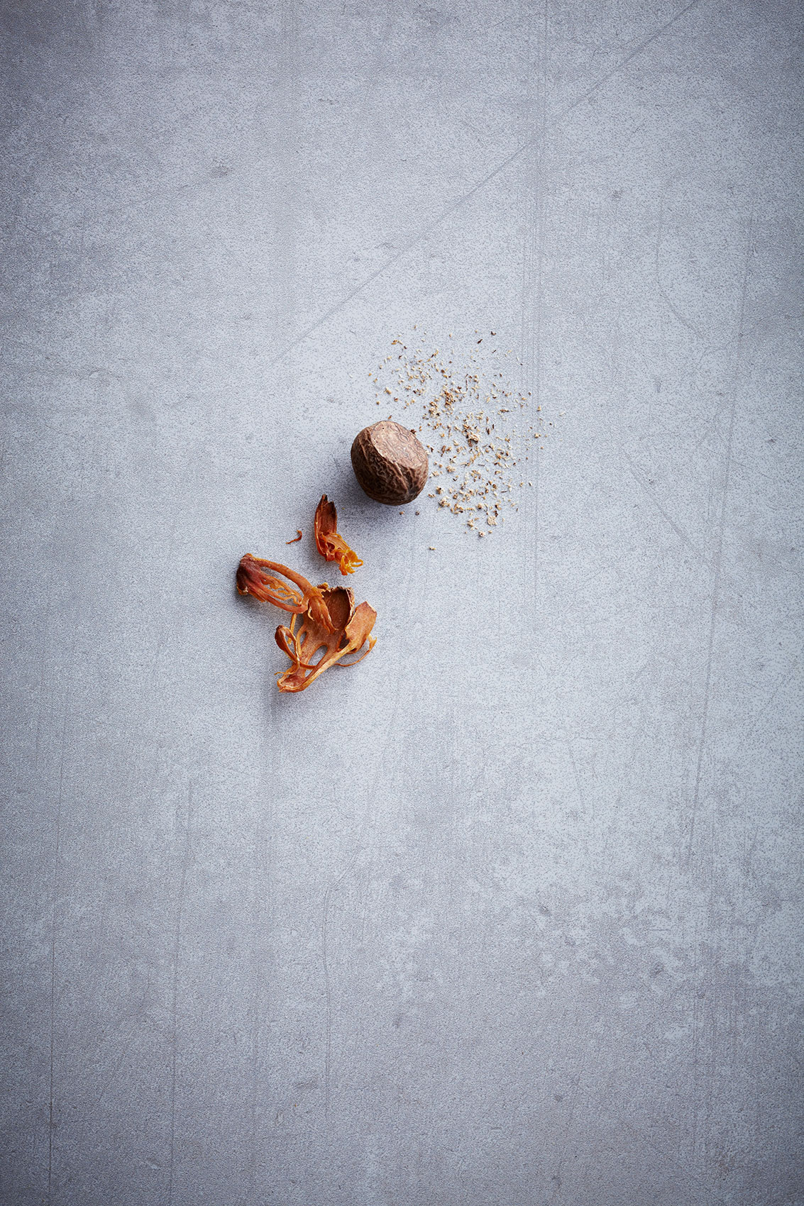 Spice Health Heroes • Whole & Ground Nutmeg on Light Stone Bench • Cookbook & Editorial Food Photography