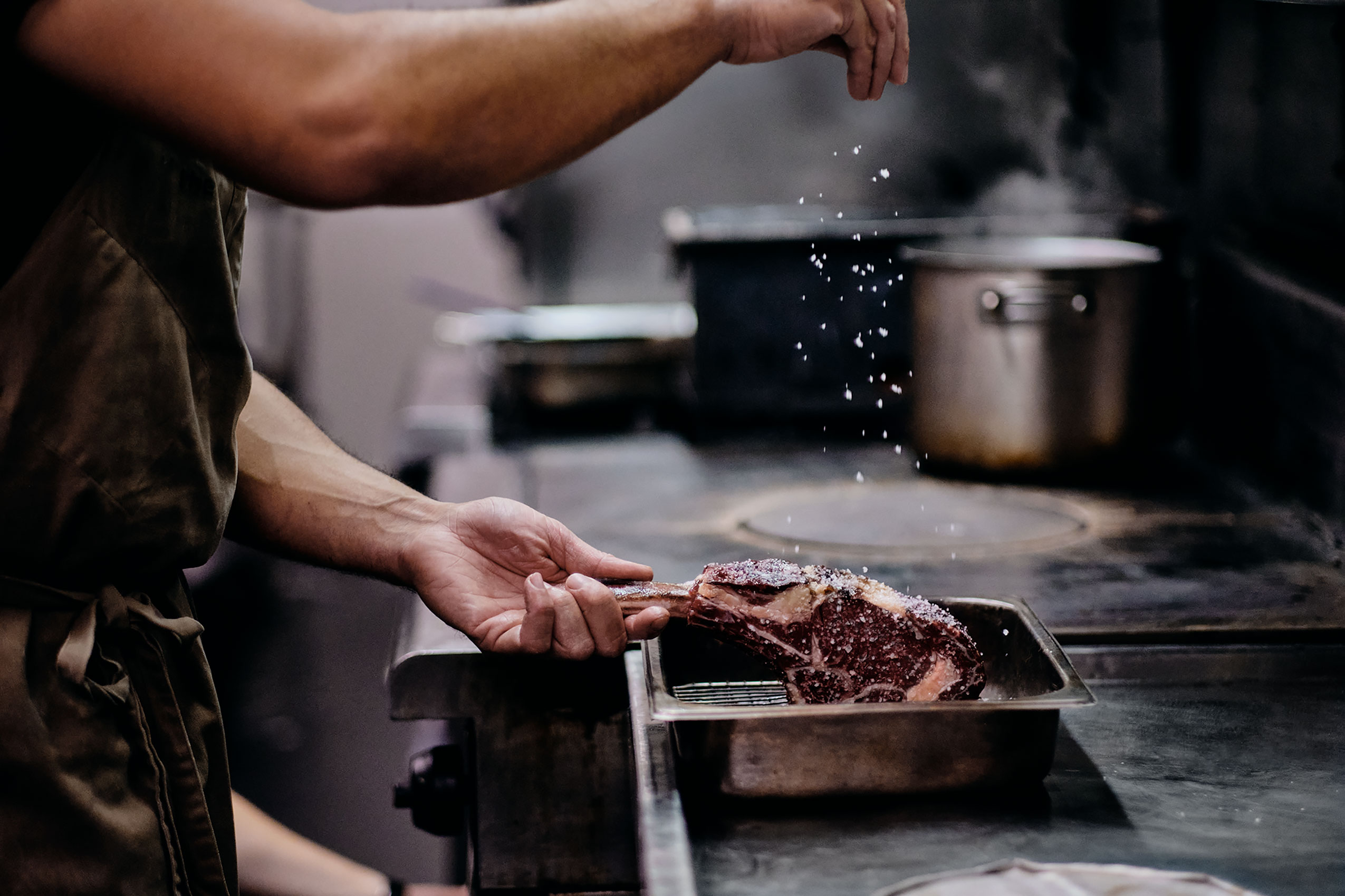 The Grove Tomahawk Steak Salting in Kitchen • Hospitality & Culinary Food Photography